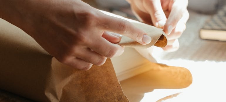 A person using clever packing tips for a smooth move to pack an item 