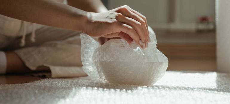 A person packing fine china