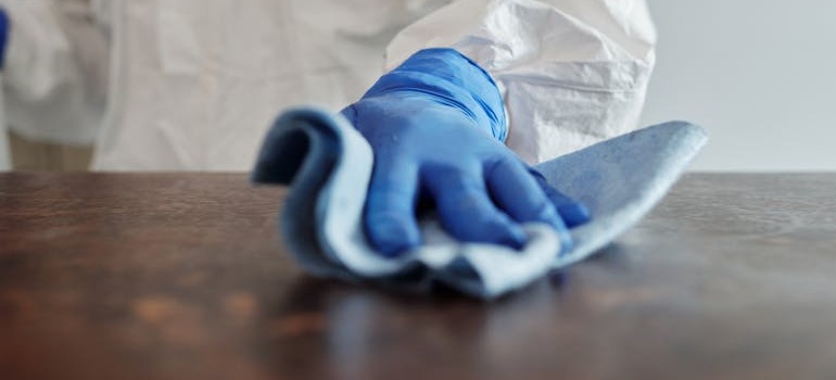A person cleaning a table