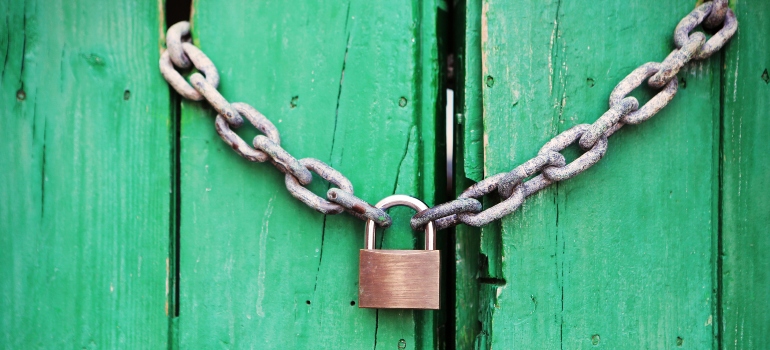 A lock on a green door.
