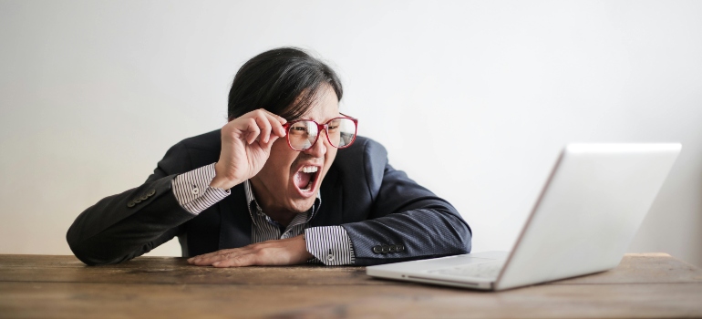 An angry man after experiencing one of the most common moving scams in Long Island CIty.