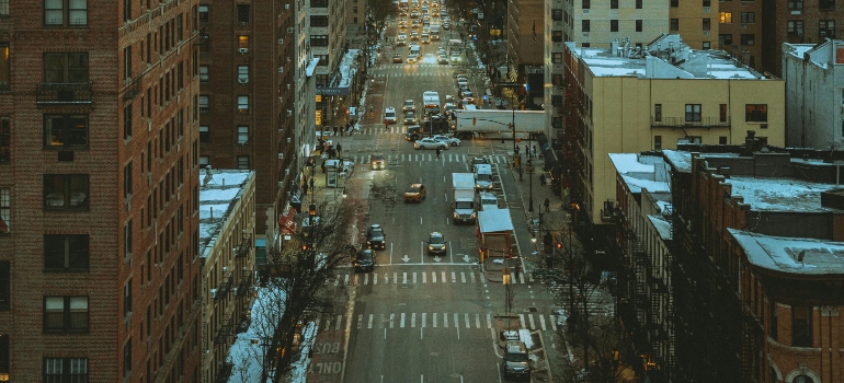 A bird's-eye view of a busy Manhattan street, highlighting the energetic pace of life in the city.