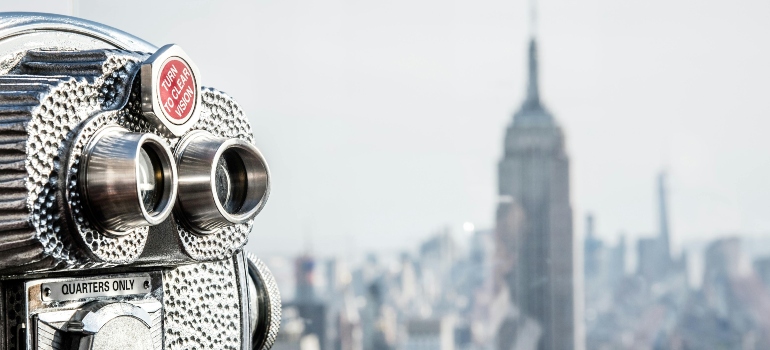 A coin-operated viewer focuses on New York City’s skyline, a reminder of the iconic cityscape during apartment hunting in SoHo.