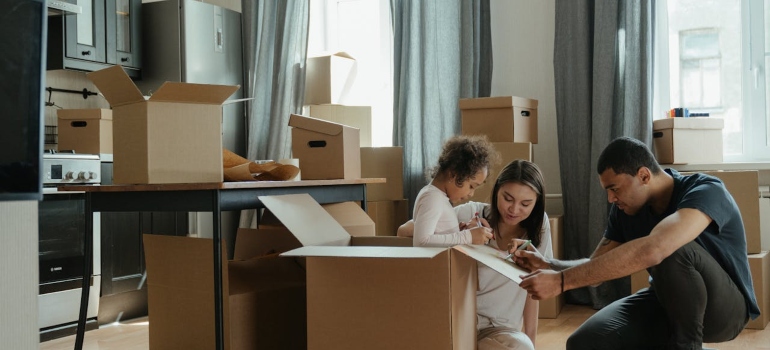 a family packing after cleaning before they move out
