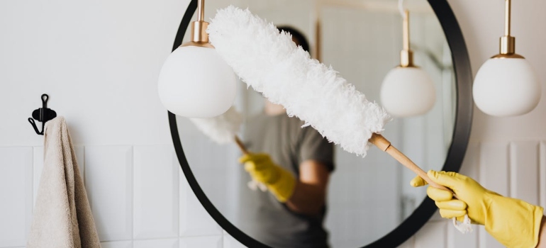 a woman cleaning bathroom before moving