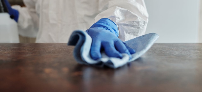 a hand with blue glove cleaning